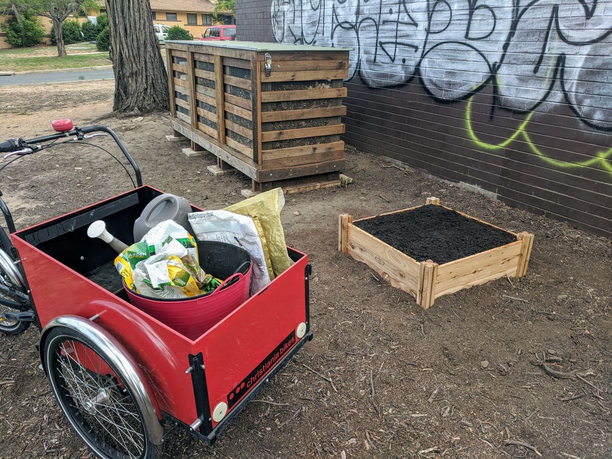 Wooden 3-bay composter, small garden bed, electric trike and tools